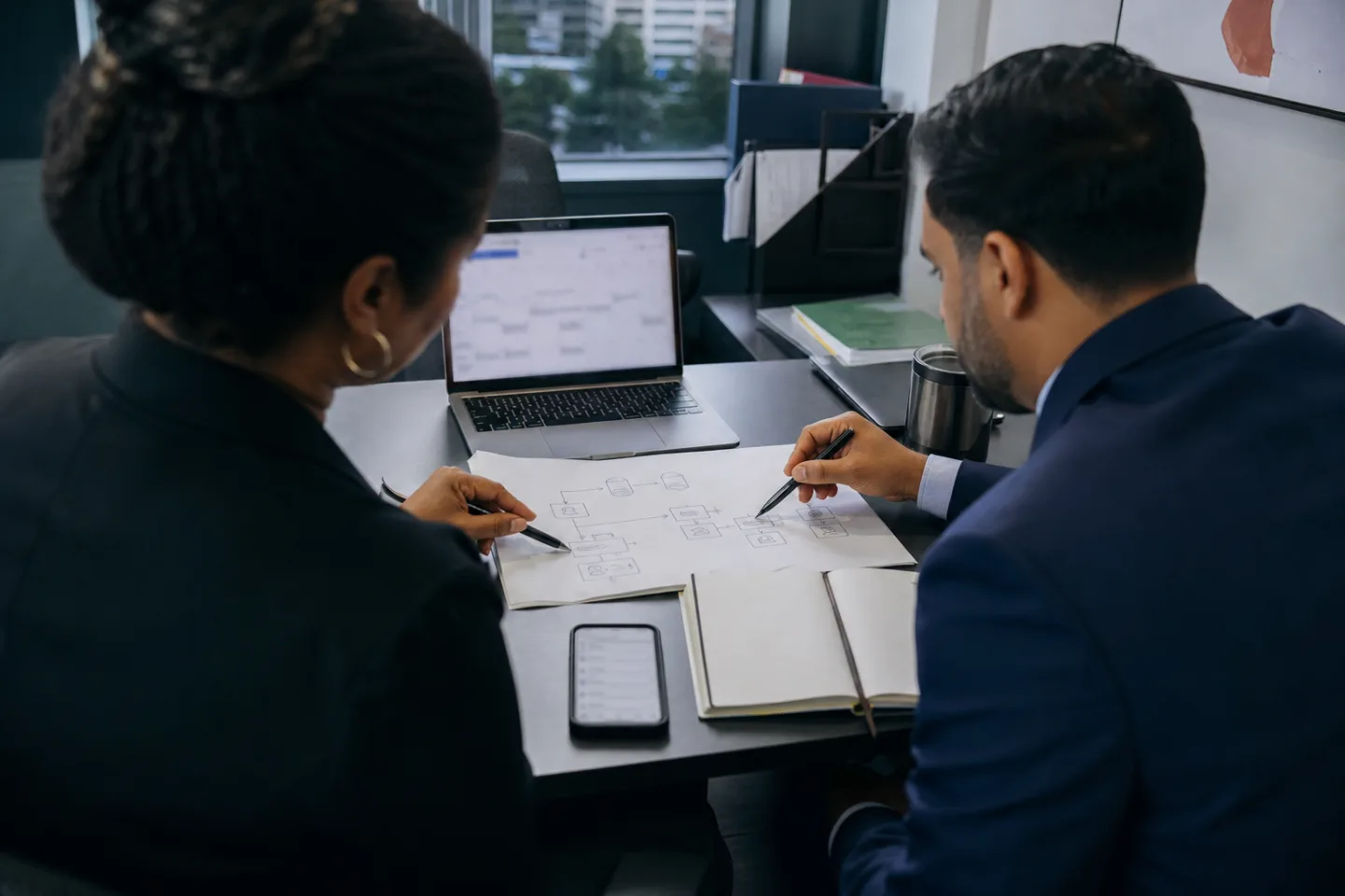 A practice manager and technical consultant reviewing a connected workflow.