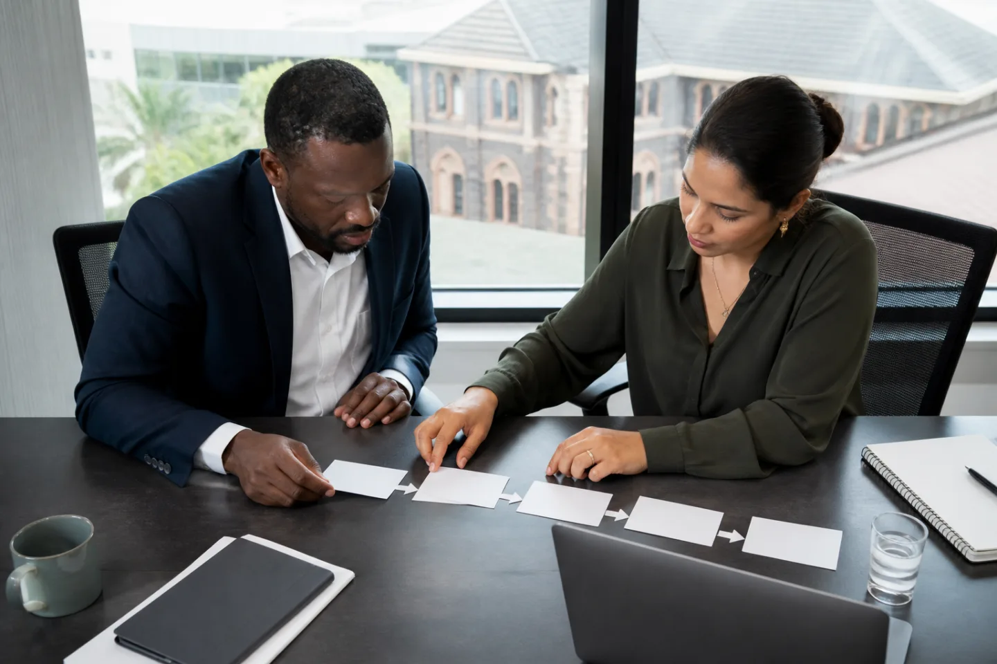 Two professionals mapping how information moves through a website workflow.